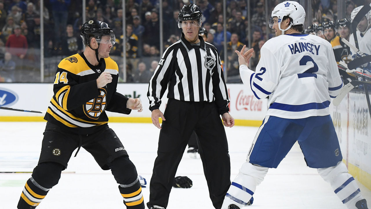 BOSTON, MA - DECEMBER 8: Chris Wagner #14 of the Boston Bruins squares off against Ron Hainsey #2 of the Toronto Maple Leafs at the TD Garden on December 8, 2018 in Boston, Massachusetts.