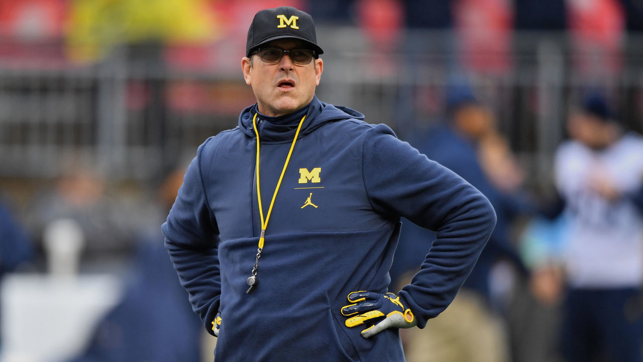 COLUMBUS, OH - NOVEMBER 24: Head Coach Jim Harbaugh of the Michigan Wolverines watches his team warm up before a game against the Ohio State Buckeyes at Ohio Stadium on November 24, 2018 in Columbus, Ohio. Ohio State defeated Michigan 62-39.
