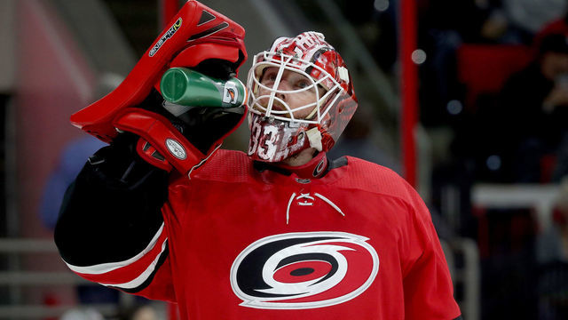RALEIGH, NC - OCTOBER 30: Scott Darling #33 of the Carolina Hurricanes hydrates during a timeout an NHL game against the Boston Bruins on October 30, 2018 at PNC Arena in Raleigh, North Carolina.