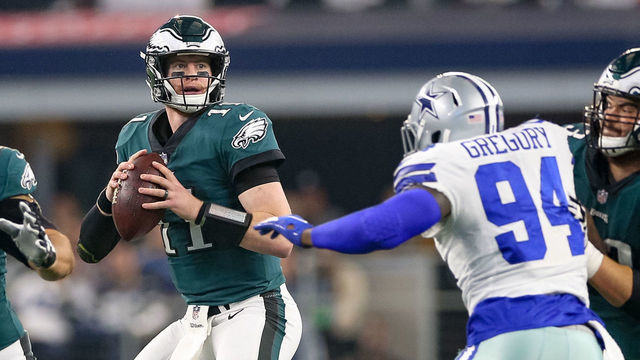 ARLINGTON, TX - DECEMBER 09: Philadelphia Eagles Quarterback Carson Wentz (11) is pressured by Dallas Cowboys Defensive End Randy Gregory (94) during the game between the Philadelphia Eagles and Dallas Cowboys on December 9, 2018 at AT&T Stadium in Arlington, TX.