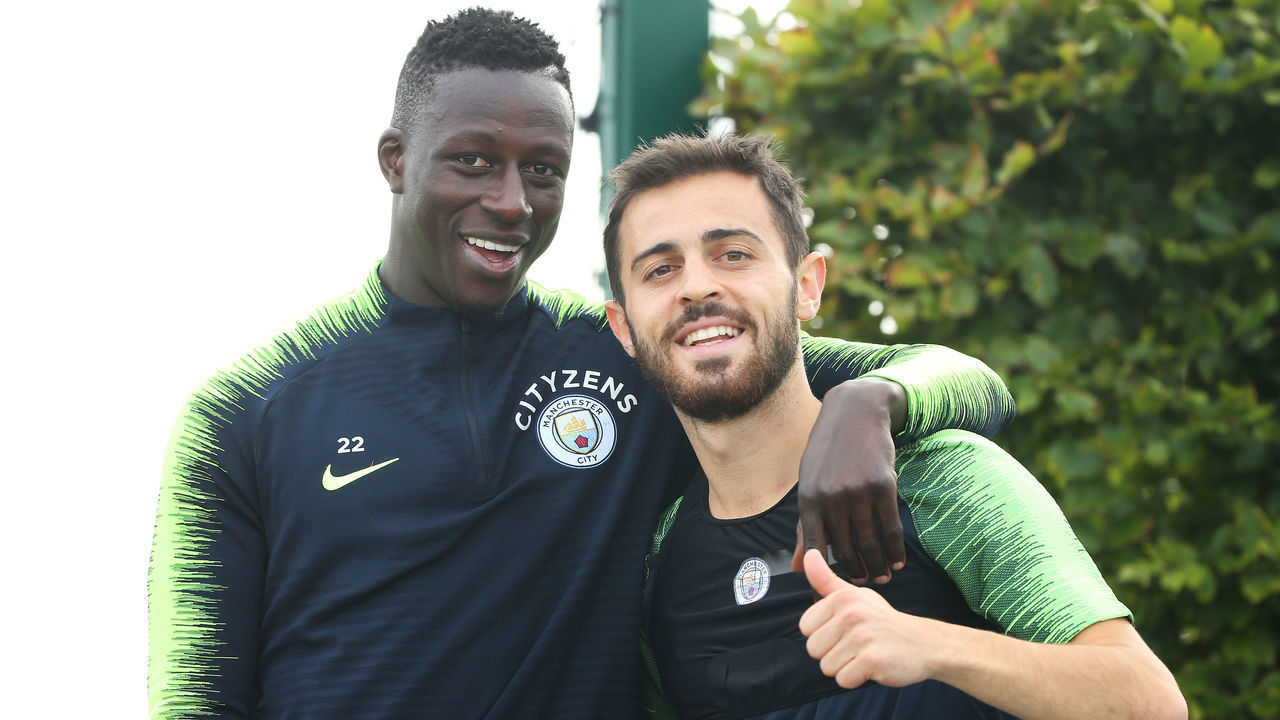 MANCHESTER, ENGLAND - AUGUST 30: Manchester City's Benjamin Mendy poses with Bernardo Silva during training at Manchester City Football Academy on August 30, 2018 in Manchester, England.