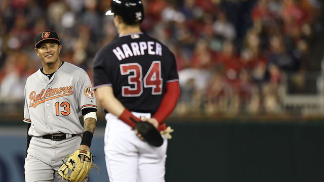 WASHINGTON, DC - JUNE 19: Bryce Harper #34 of the Washington Nationals talks with Manny Machado #13 of the Baltimore Orioles after hitting a RBI double in the fifth inning at Nationals Park on June 19, 2018 in Washington, DC.