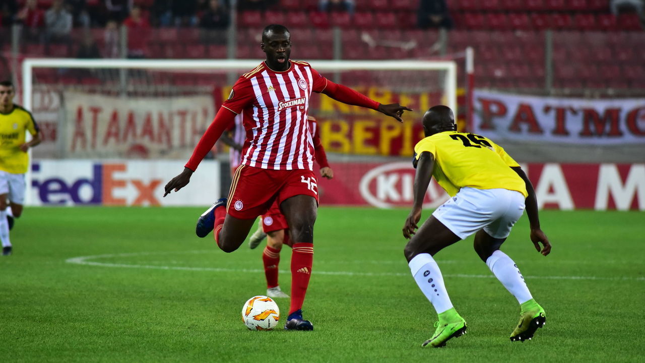 STADIO GEORGIOS KARAISKAKIS, ATHENS, ATTIKI, GREECE - 2018/11/08: Yaya Toure (no 42) of Olympiacos, tries to pass the ball under the pressure of Jerry Prempeh (no 26) of F91 Dudelange. Olympiacos has won F91 Dudelange 5-1 for the UEFA Europa League.