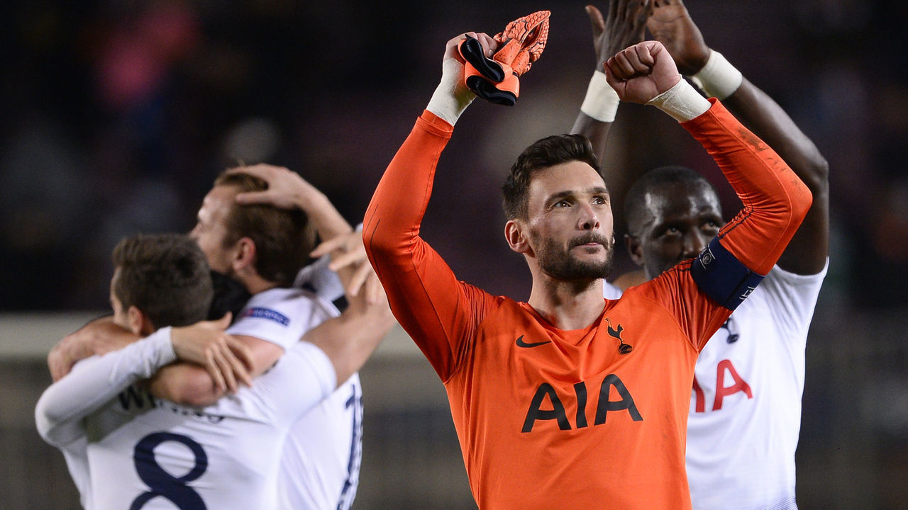 Tottenham Hotspur's French goalkeeper Hugo Lloris and teammates celebrate their qualification for the next round during the UEFA Champions League group B football match between FC Barcelona and Tottenham Hotspur at the Camp Nou stadium in Barcelona on December 11, 2018.