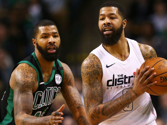 BOSTON, MA - MARCH 14: Markieff Morris #5 of the Washington Wizards is guarded by his brother Marcus Morris #13 of the Boston Celtics in the fourth quarter during a game at TD Garden on March 14, 2018 in Boston, Massachusetts.
