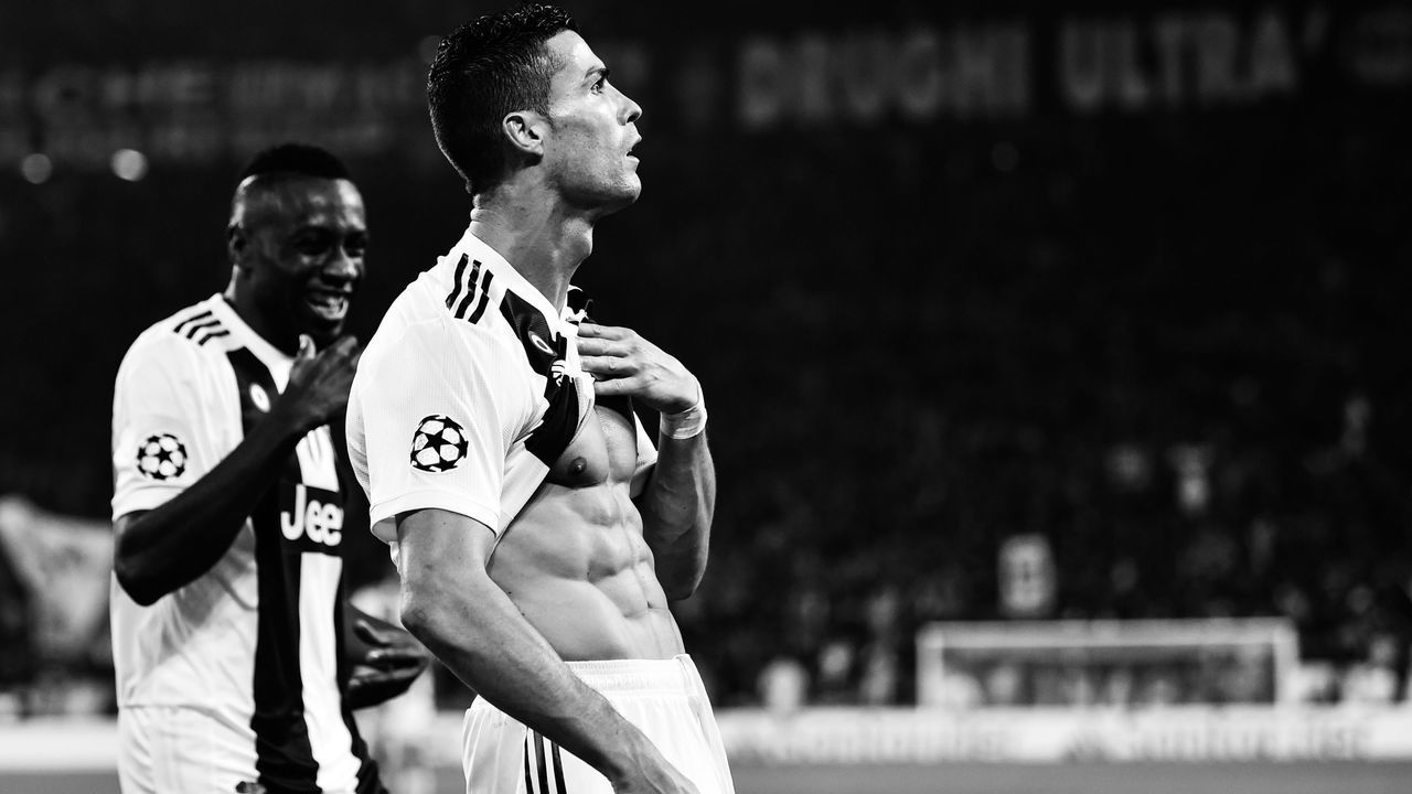 Juventus' Portuguese forward Cristiano Ronaldo shows his six-pack as he celebrates with Juventus' French midfielder Blaise Matuidi (L) after opening the scoring during the UEFA Champions League group H football match Juventus vs Manchester United at the Allianz stadium in Turin on November 7, 2018.