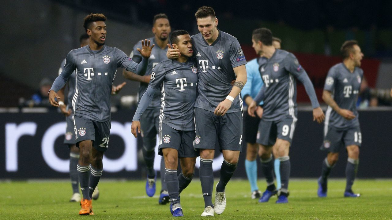 (L-R), Kingley Coman of Bayern Munchen, Thiago Alcantara of Bayern Munchen, Niklas Sule of Bayern Munchen during the UEFA Champions League group E match between Ajax Amsterdam and Bayern Munich at the Johan Cruijff Arena on December 12, 2018 in Amsterdam, The Netherlands