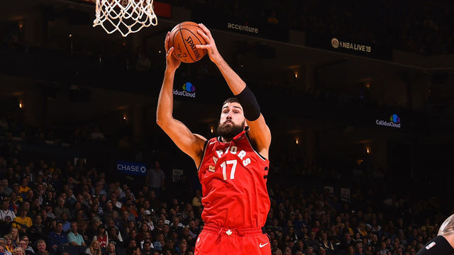 OAKLAND, CA - DECEMBER 12: Jonas Valanciunas #17 of the Toronto Raptors gets the rebound against the Golden State Warriors on December 12, 2018 at ORACLE Arena in Oakland, California. NOTE TO USER: User expressly acknowledges and agrees that, by downloading and or using this photograph, user is consenting to the terms and conditions of Getty Images License Agreement. Mandatory Copyright Notice: Copyright 2018 NBAE