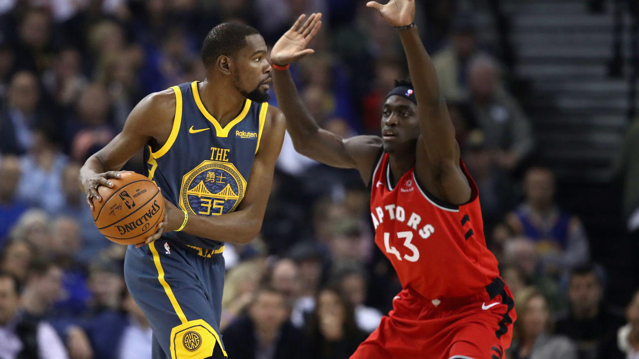 OAKLAND, CA - DECEMBER 12: Kevin Durant #35 of the Golden State Warriors is guarded by Pascal Siakam #43 of the Toronto Raptors at ORACLE Arena on December 12, 2018 in Oakland, California.