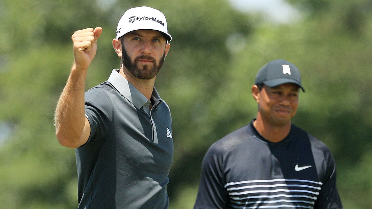 SOUTHAMPTON, NY - JUNE 15: Dustin Johnson of the United States celebrates making a birdie on the seventh hole as Tiger Woods of the United States looks on during the second round of the 2018 U.S. Open at Shinnecock Hills Golf Club on June 15, 2018 in Southampton, New York.