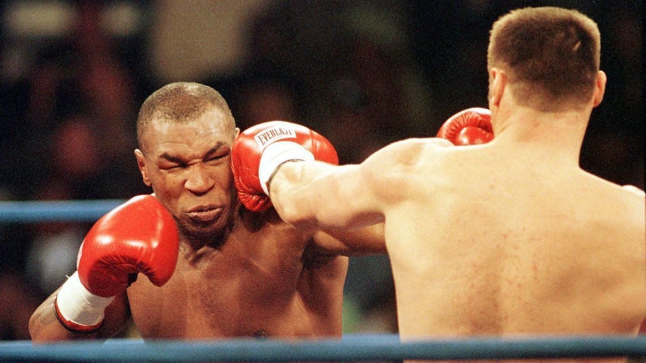 AUBURN HILLS, MI - OCTOBER 21: Boxer Mike Tyson of the United States (L) and Andrew Golota of Poland trade punches during the second round of their fight at the Palace of Auburn Hills, Michigan, 20 October 2000. Galota refused to answer the bell for the third round of their fight. Tyson won the match on a TKO making this the 49th victory of his career. AFP PHOTO Daniel Lippitt