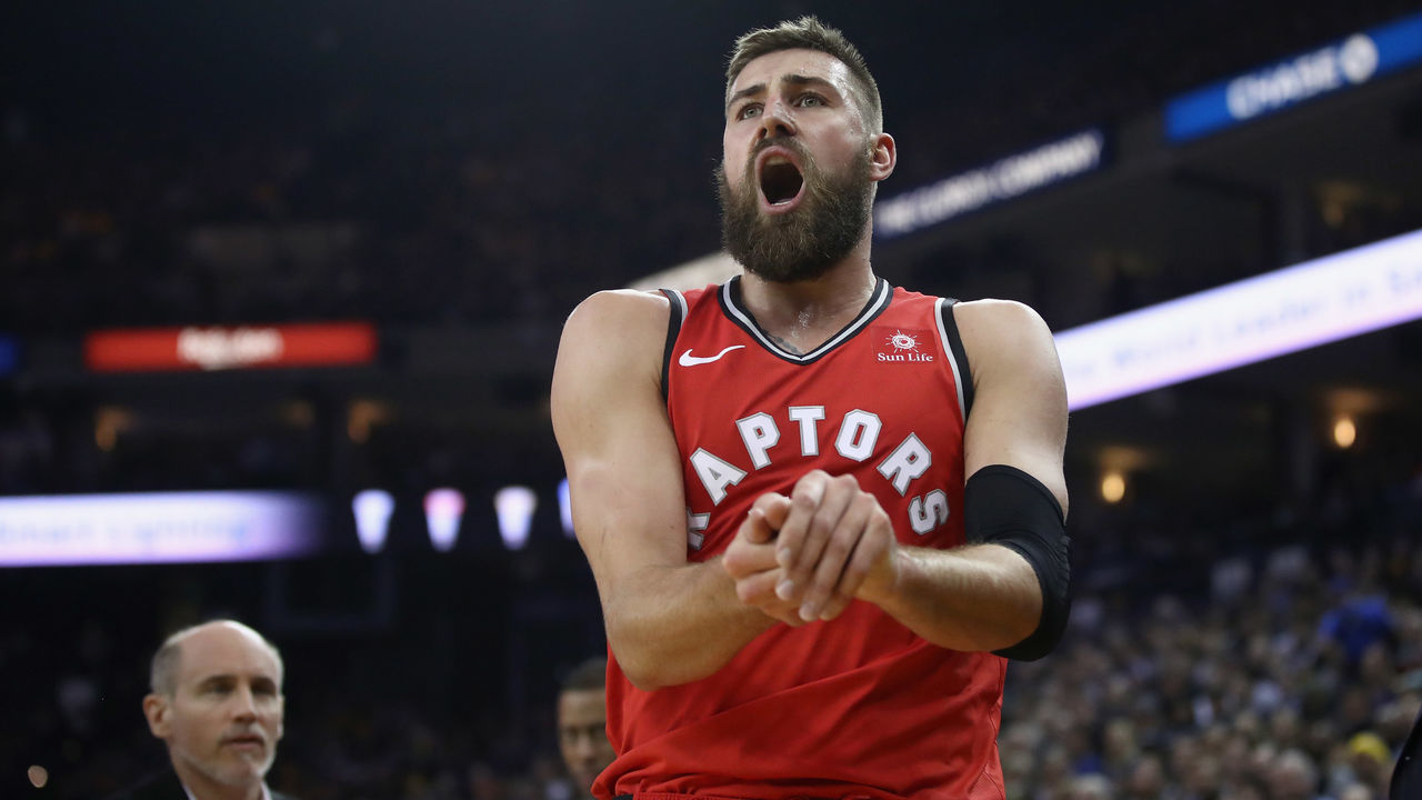 OAKLAND, CA - DECEMBER 12: Jonas Valanciunas #17 of the Toronto Raptors grimaces in pain after hurting his finger against the Golden State Warriors at ORACLE Arena on December 12, 2018 in Oakland, California.