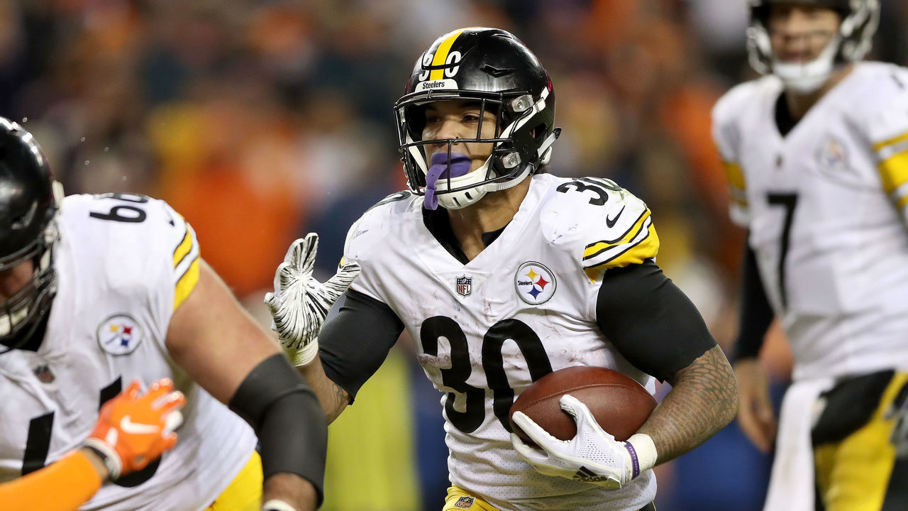 DENVER, CO - NOVEMBER 25: James Conner #30 of the Pittsburgh Steelers carries the ball against the Denver Broncos at Broncos Stadium at Mile High on November 25, 2018 in Denver, Colorado.
