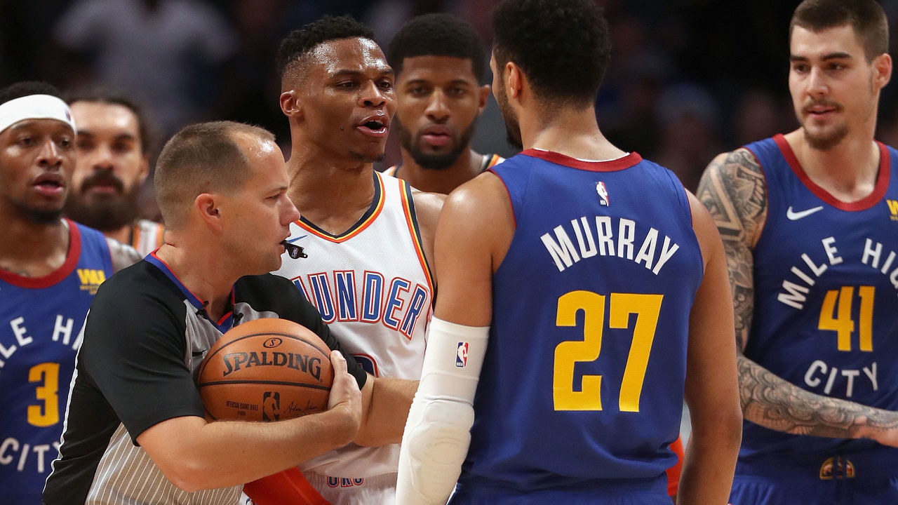 DENVER, COLORADO - DECEMBER 14: Russell Westbrook #0 of the Oklahoma Thunder is restrained by referee John Goble #30 from Jamal Murray #27 of the Denver Nuggets in the fourth quarter at the Pepsi Center on December 14, 2018 in Denver, Colorado.