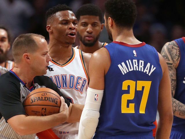 DENVER, COLORADO - DECEMBER 14: Russell Westbrook #0 of the Oklahoma Thunder is restrained by referee John Goble #30 from Jamal Murray #27 of the Denver Nuggets in the fourth quarter at the Pepsi Center on December 14, 2018 in Denver, Colorado.