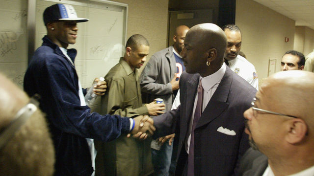 CLEVELAND - APRIL 8: High school phenomenon LeBron James #23 of the St. Vincent-St. Mary Fighting Irish shakes hands with Michael Jordan #23 of the Washington Wizards after Jordan's game against the Cleveland Cavaliers at Gund Arena on April 8, 2003 in Cleveland, Ohio. The Wizards won 100-91. NOTE TO USER: User expressly acknowledges and agrees that, by downloading and/or using this Photograph, User is consenting to the terms and conditions of the Getty Images License Agreement. Copyright 2003 NBAE