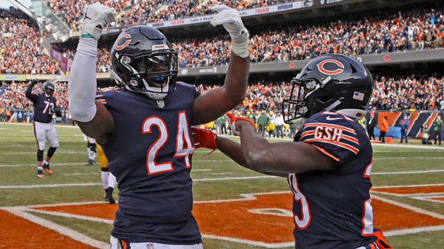 CHICAGO, IL - DECEMBER 16: Jordan Howard #24 and Tarik Cohen #29 of the Chicago Bears celebrate after Howard scored a touchdown in the first quarter against the Green Bay Packers with at Soldier Field on December 16, 2018 in Chicago, Illinois.