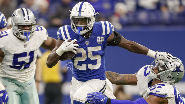 INDIANAPOLIS, IN - DECEMBER 16: Marlon Mack #25 of the Indianapolis Colts puts the stiff arm to Damien Wilson #57 of the Dallas Cowboys during the game at Lucas Oil Stadium on December 16, 2018 in Indianapolis, Indiana.