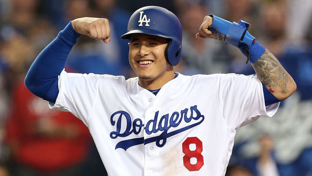 LOS ANGELES, CA - OCTOBER 27: Manny Machado #8 of the Los Angeles Dodgers waits for Yasiel Puig #66 at home plate after Puig hit a three-run home run in the sixth inning during Game 4 of the 2018 World Series against the Boston Red Sox at Dodger Stadium on Saturday, October 27, 2018 in Los Angeles, California.