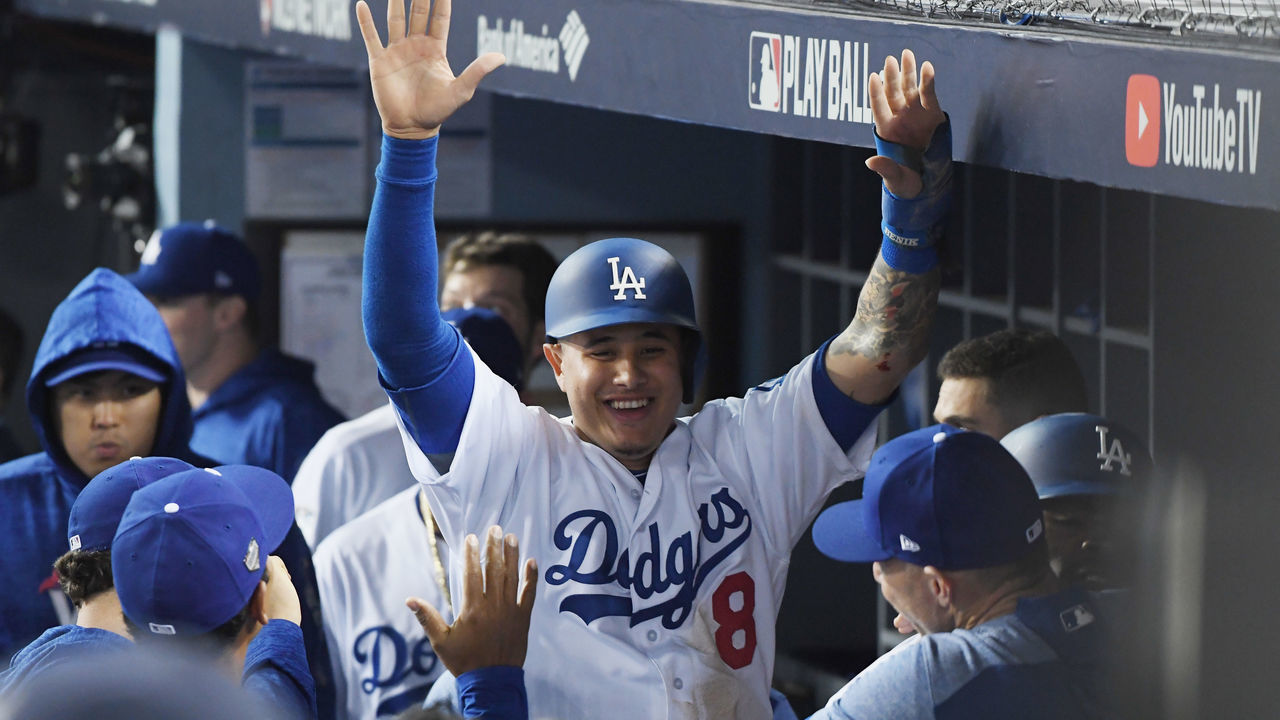 LOS ANGELES, CA - OCTOBER 27: Manny Machado #8 of the Los Angeles Dodgers celebrates with teammates in the dugout after scoring on a three-run home run hit by Yasiel Puig #66 (not in photo) in the sixth inning of Game Four of the 2018 World Series against the Boston Red Sox at Dodger Stadium on October 27, 2018 in Los Angeles, California.