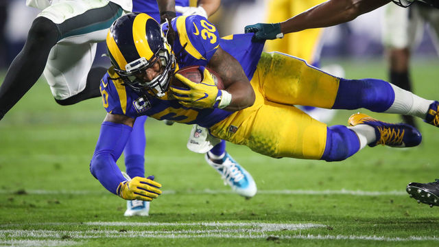 LOS ANGELES, CA - DECEMBER 16: Running back Todd Gurley #30 of the Los Angeles Rams makes a run play in the second quarter in front of cornerback Rasul Douglas #32 of the Philadelphia Eagles at Los Angeles Memorial Coliseum on December 16, 2018 in Los Angeles, California.