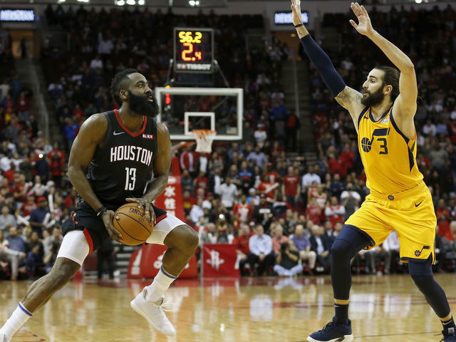 HOUSTON, TX - DECEMBER 17: James Harden #13 of the Houston Rockets pulls up to take a three point shot defended by Ricky Rubio #3 of the Utah Jazz in the second half at Toyota Center on December 17, 2018 in Houston, Texas.