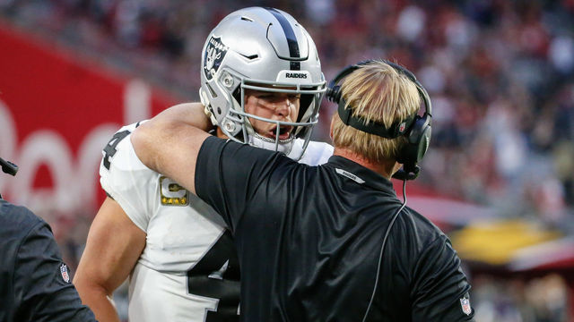 GLENDALE, AZ - NOVEMBER 18: Oakland Raiders quarterback Derek Carr (4) is hugged by Oakland Raiders head coach Jon Gruden during the NFL football game between the Oakland Raiders and the Arizona Cardinals on November 18, 2018 at State Farm Stadium in Glendale, Arizona.