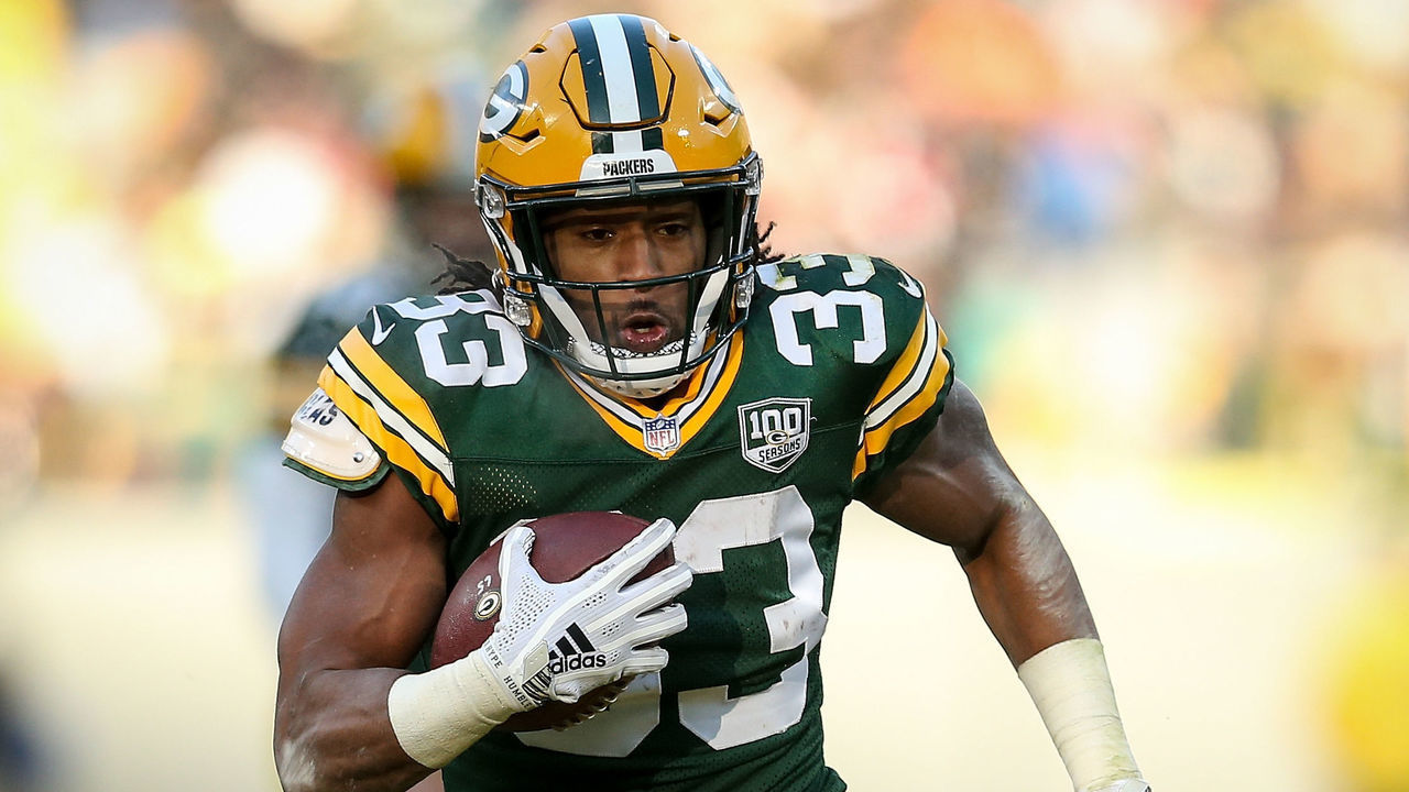 GREEN BAY, WISCONSIN - DECEMBER 09: Aaron Jones #33 of the Green Bay Packers runs with the ball in the third quarter against the Atlanta Falcons at Lambeau Field on December 09, 2018 in Green Bay, Wisconsin.