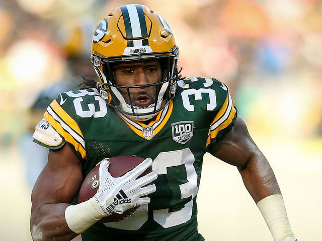 GREEN BAY, WISCONSIN - DECEMBER 09: Aaron Jones #33 of the Green Bay Packers runs with the ball in the third quarter against the Atlanta Falcons at Lambeau Field on December 09, 2018 in Green Bay, Wisconsin.
