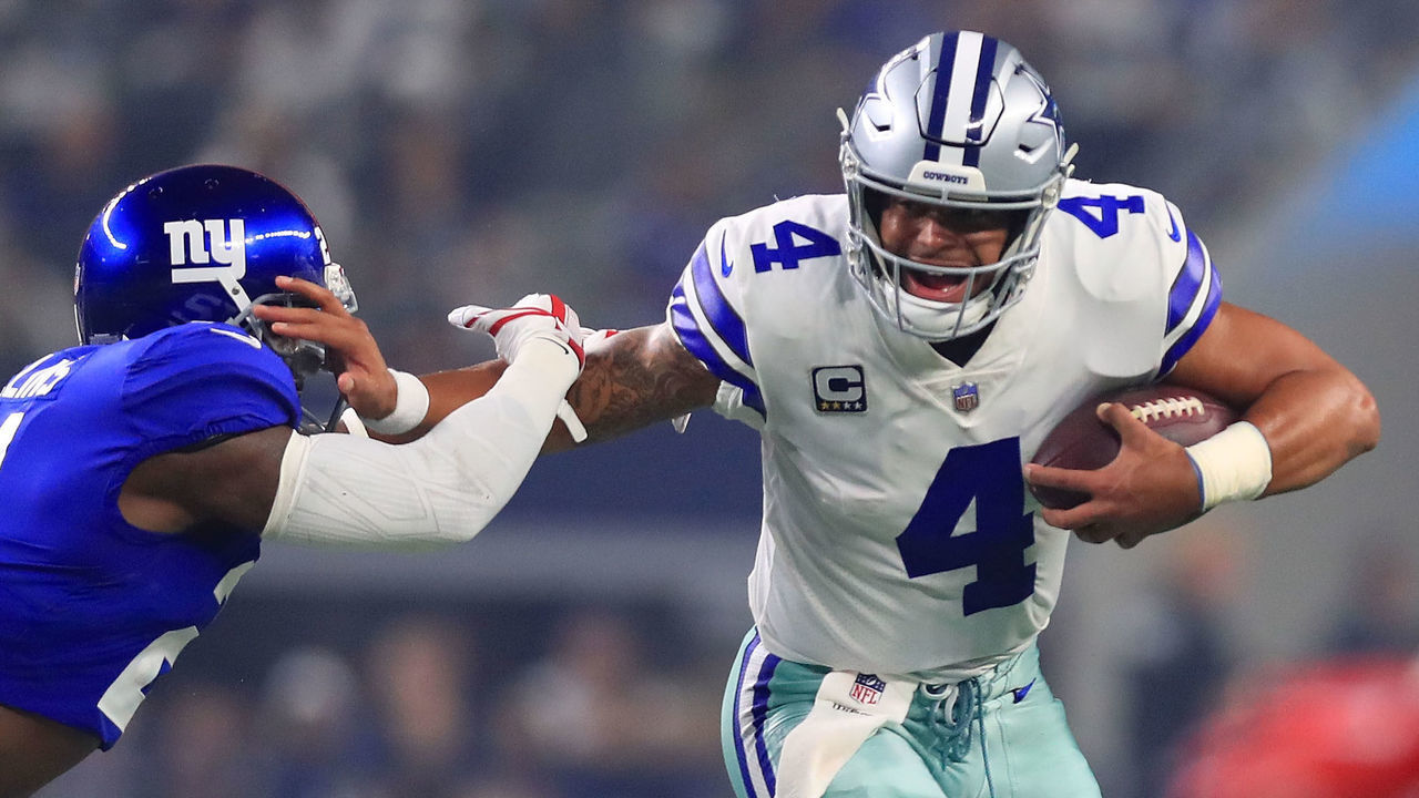 ARLINGTON, TX - SEPTEMBER 16: Landon Collins #21 of the New York Giants tries to grab Dak Prescott #4 of the Dallas Cowboys in the first quarter of a football game at AT&T Stadium on September 16, 2018 in Arlington, Texas.