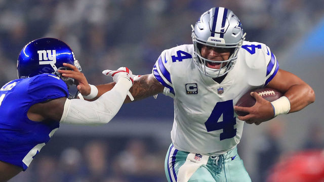 ARLINGTON, TX - SEPTEMBER 16: Landon Collins #21 of the New York Giants tries to grab Dak Prescott #4 of the Dallas Cowboys in the first quarter of a football game at AT&T Stadium on September 16, 2018 in Arlington, Texas.