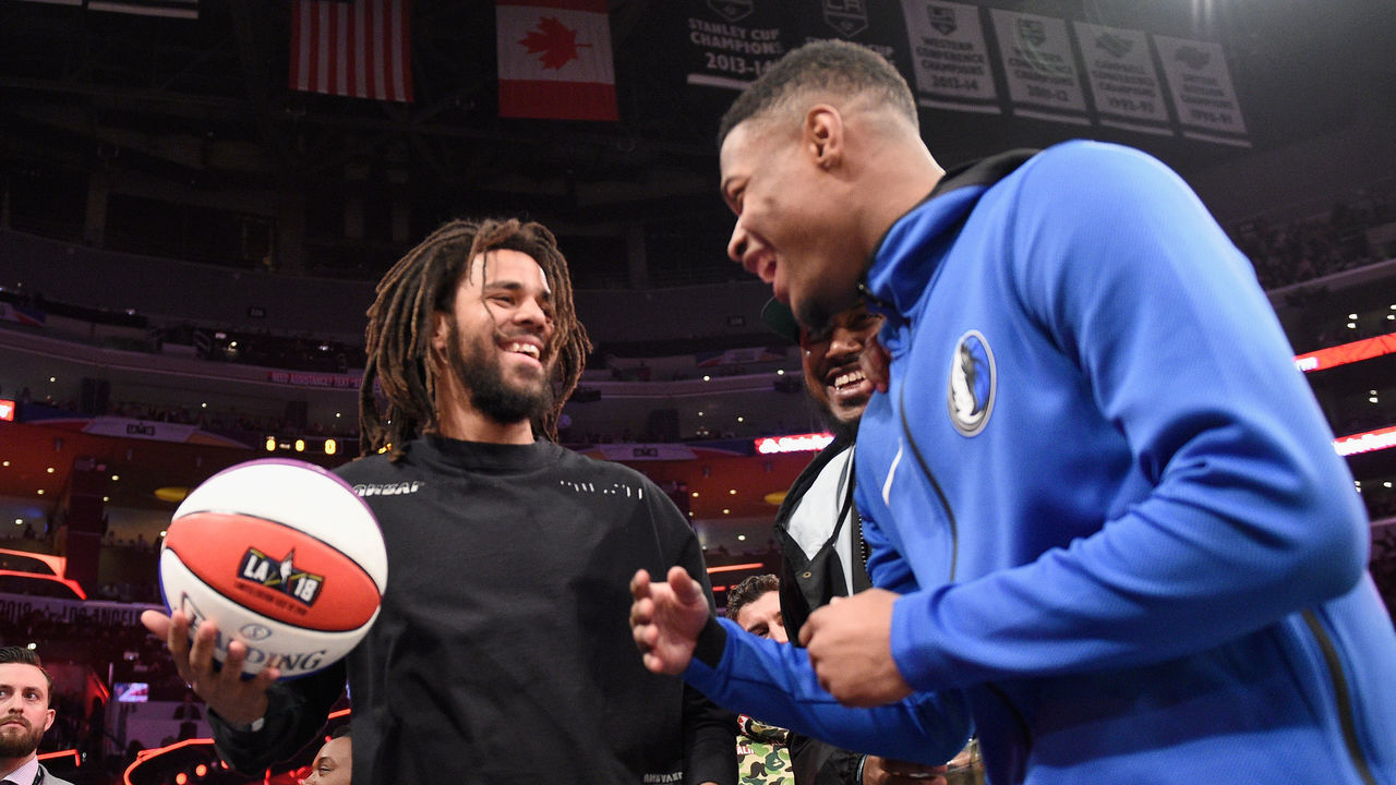 LOS ANGELES, CA - FEBRUARY 17: J. Cole and Dennis Smith Jr. attend the 2018 Verizon Slam Dunk Contest at Staples Center on February 17, 2018 in Los Angeles, California.