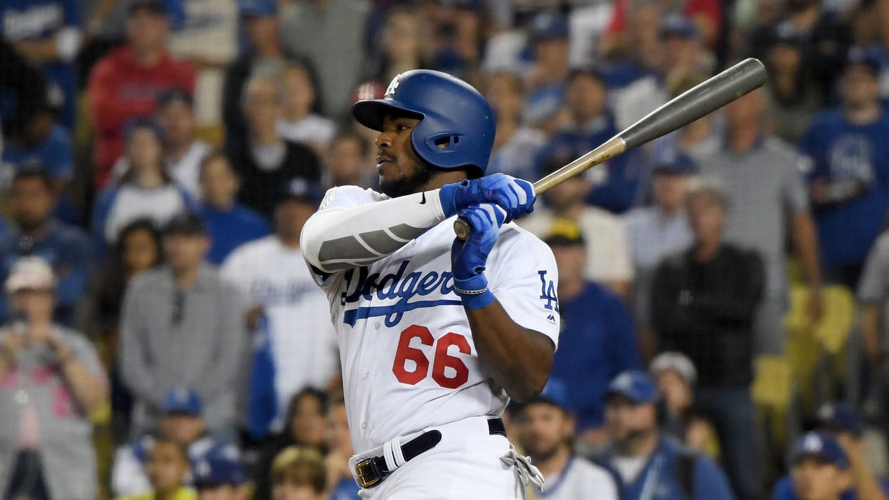 LOS ANGELES, CA - OCTOBER 26: Yasiel Puig #66 of the Los Angeles Dodgers hits a single that brings home the tying run during the thirteenth inning against the Boston Red Sox in Game Three of the 2018 World Series at Dodger Stadium on October 26, 2018 in Los Angeles, California.