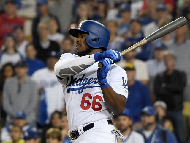 LOS ANGELES, CA - OCTOBER 26: Yasiel Puig #66 of the Los Angeles Dodgers hits a single that brings home the tying run during the thirteenth inning against the Boston Red Sox in Game Three of the 2018 World Series at Dodger Stadium on October 26, 2018 in Los Angeles, California.