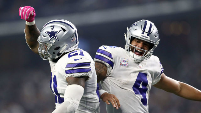 ARLINGTON, TX - OCTOBER 14: Ezekiel Elliott #21 and Dak Prescott #4 of the Dallas Cowboys celebrate the fourth quarter touchdown against the Jacksonville Jaguars at AT&T Stadium on October 14, 2018 in Arlington, Texas.