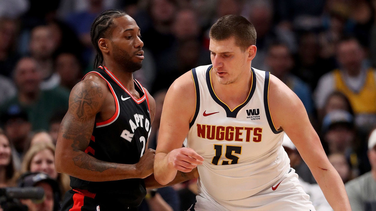 DENVER, COLORADO - DECEMBER 16: Kawhi Leonard #2 of the Toronto Raptors guards Nikola Jokic #15 of the Denver Nuggets at the Pepsi Center on December 16, 2018 in Denver, Colorado.