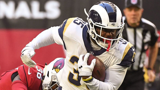 GLENDALE, ARIZONA - DECEMBER 23: C.J. Anderson #35 of the Los Angeles Rams carries against Tre Boston #33 and Budda Baker #36 of the Arizona Cardinals in the first half at State Farm Stadium on December 23, 2018 in Glendale, Arizona.