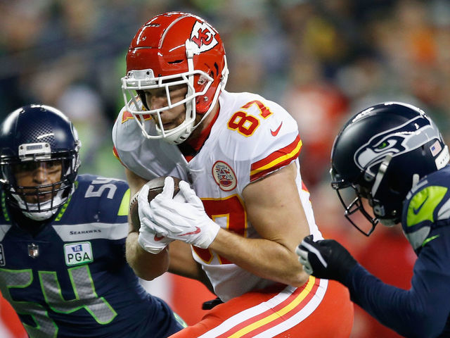 SEATTLE, WA - DECEMBER 23: Travis Kelce #87 of the Kansas City Chiefs tries to get past Bobby Wagner #54 (L) and Delano Hill #42 (R) of the Seattle Seahawks during the second quarter of the game at CenturyLink Field on December 23, 2018 in Seattle, Washington.