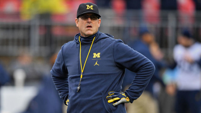 COLUMBUS, OH - NOVEMBER 24: Head Coach Jim Harbaugh of the Michigan Wolverines watches his team warm up before a game against the Ohio State Buckeyes at Ohio Stadium on November 24, 2018 in Columbus, Ohio. Ohio State defeated Michigan 62-39.