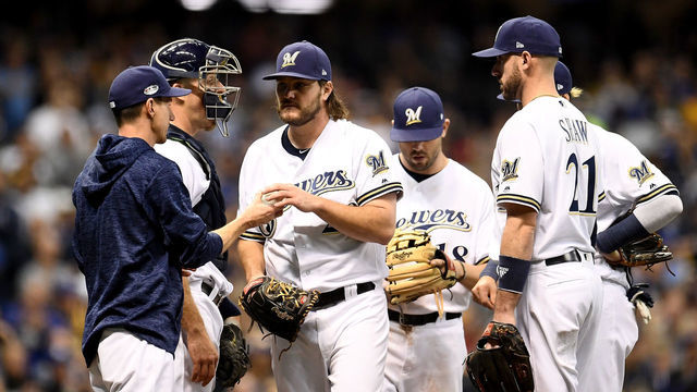 MILWAUKEE, WI - OCTOBER 19: Wade Miley #20 of the Milwaukee Brewers is relieved by manager Craig Counsell #30 against the Los Angeles Dodgers during the fifth inning in Game Six of the National League Championship Series at Miller Park on October 19, 2018 in Milwaukee, Wisconsin.