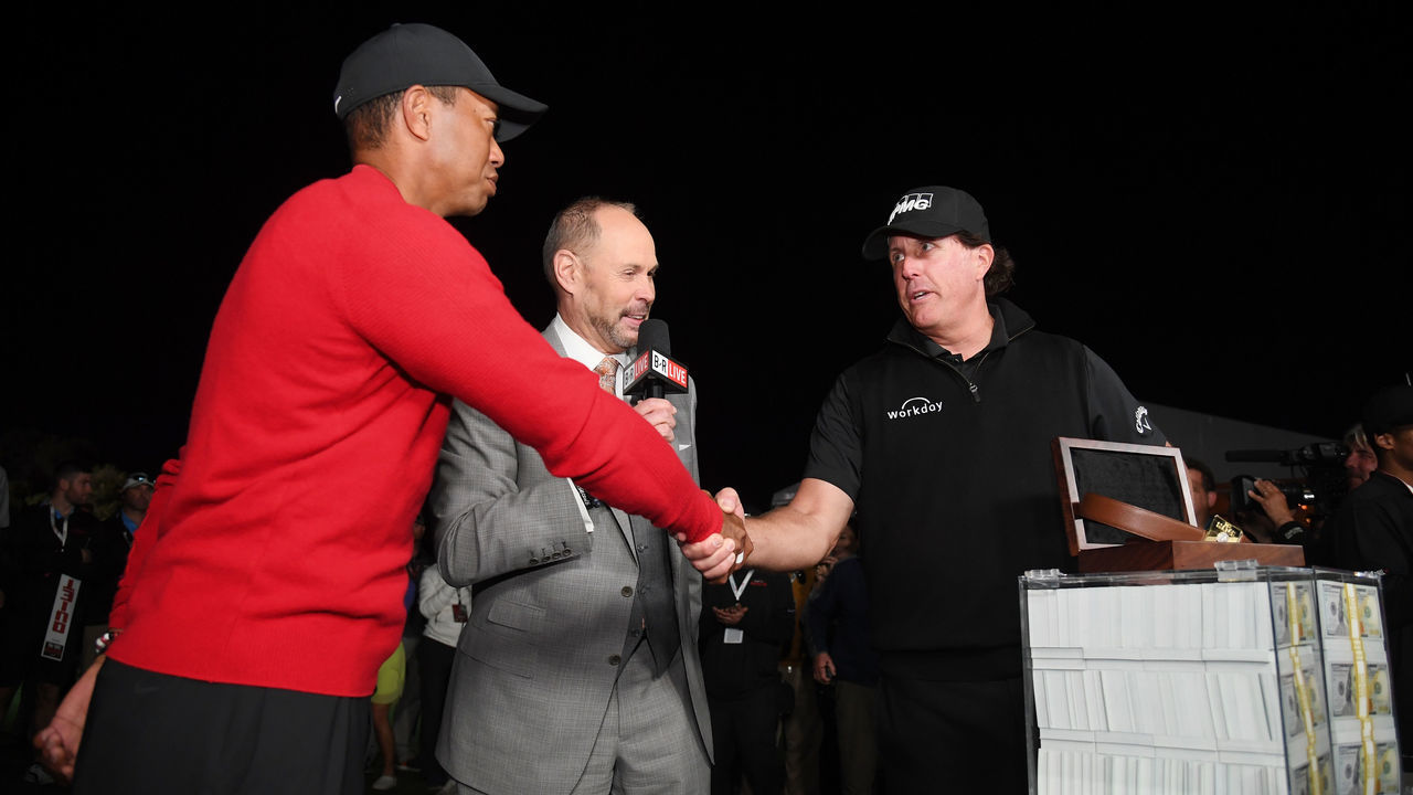 LAS VEGAS, NV - NOVEMBER 23: Phil Mickelson celebrates with the winnings after defeating Tiger Woods as Ernie Johnson looks on during The Match: Tiger vs Phil at Shadow Creek Golf Course on November 23, 2018 in Las Vegas, Nevada.
