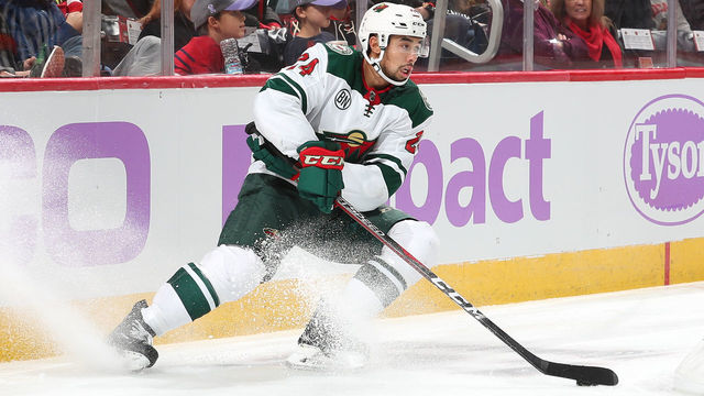 CHICAGO, IL - NOVEMBER 18: Matt Dumba #24 of the Minnesota Wild grabs the puck in the second period against the Chicago Blackhawks at the United Center on November 18, 2018 in Chicago, Illinois. The Chicago Blackhawks defeated the Minnesota Wild 3-1.