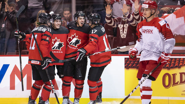 VANCOUVER, BC - DECEMBER 26: Morgan Frost #26 of Canada celebrates with teammates Jaret Anderson-Dolan #11, Ty Smith #24 and Nick Suzuki #17 after scoring his third goal of the game as Lasse Mortensen #4 of Denmark skates past in Group A hockey action of the 2019 IIHF World Junior Championship action on December, 26, 2018 at Rogers Arena in Vancouver, British Columbia, Canada.