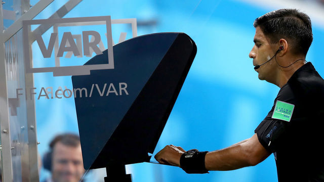 SARANSK, RUSSIA - JUNE 25: Referee Enrique Caceres reviews the VAR footage before giving a yellow card to Cristiano Ronaldo of Portugal during the 2018 FIFA World Cup Russia group B match between Iran and Portugal at Mordovia Arena on June 25, 2018 in Saransk, Russia.