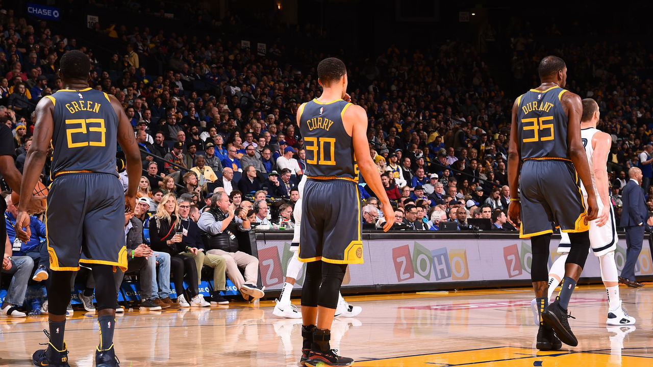 OAKLAND, CA - DECEMBER 17: Draymond Green #23, Stephen Curry #30 and Kevin Durant #35 of the Golden State Warriors look on during the game against the Memphis Grizzlies on December 17, 2018 at ORACLE Arena in Oakland, California. NOTE TO USER: User expressly acknowledges and agrees that, by downloading and or using this photograph, user is consenting to the terms and conditions of Getty Images License Agreement. Mandatory Copyright Notice: Copyright 2018 NBAE