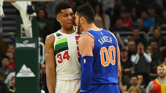 MILWAUKEE, WISCONSIN - DECEMBER 27: Giannis Antetokounmpo #34 of the Milwaukee Bucks and Enes Kanter #00 of the New York Knicks exchange words during the second half of a game at Fiserv Forum on December 27, 2018 in Milwaukee, Wisconsin. Enes Kanter #00 was ejected from the game.