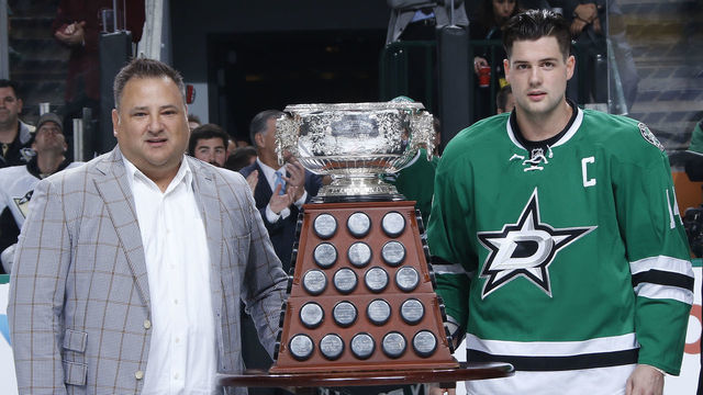 DALLAS, TX - OCTOBER 8: Dallas Stars owner Tom Gaglardi and Jamie Benn #14 of the Dallas Stars pose with the Art Ross Trophy which was won by Benn in the 2014-2015 season before a game against the Pittsburgh Penguins at the American Airlines Center on October 8, 2015 in Dallas, Texas.