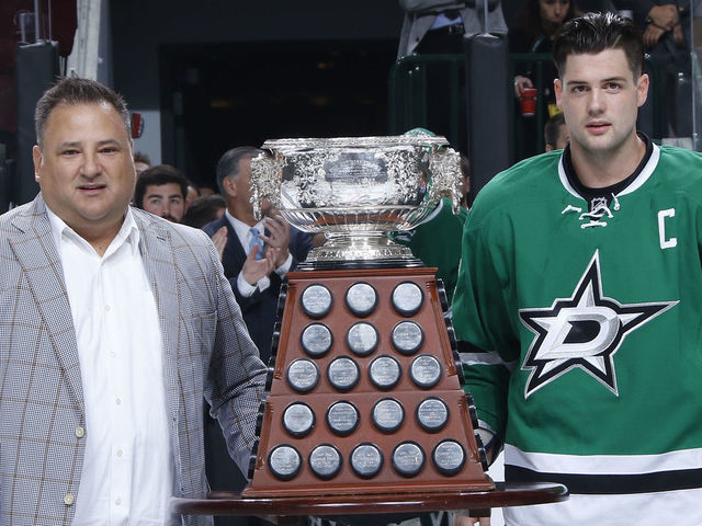 DALLAS, TX - OCTOBER 8: Dallas Stars owner Tom Gaglardi and Jamie Benn #14 of the Dallas Stars pose with the Art Ross Trophy which was won by Benn in the 2014-2015 season before a game against the Pittsburgh Penguins at the American Airlines Center on October 8, 2015 in Dallas, Texas.