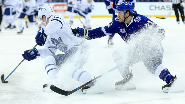 TAMPA, FL - MARCH 20: Mitchell Marner #16 of the Toronto Maple Leafs and Brayden Point #21 of the Tampa Bay Lightning fight for the puck during a game at Amalie Arena on March 20, 2018 in Tampa, Florida.