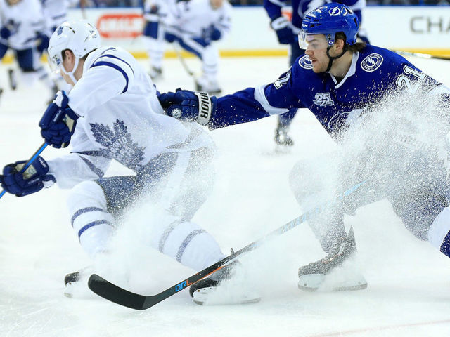 TAMPA, FL - MARCH 20: Mitchell Marner #16 of the Toronto Maple Leafs and Brayden Point #21 of the Tampa Bay Lightning fight for the puck during a game at Amalie Arena on March 20, 2018 in Tampa, Florida.